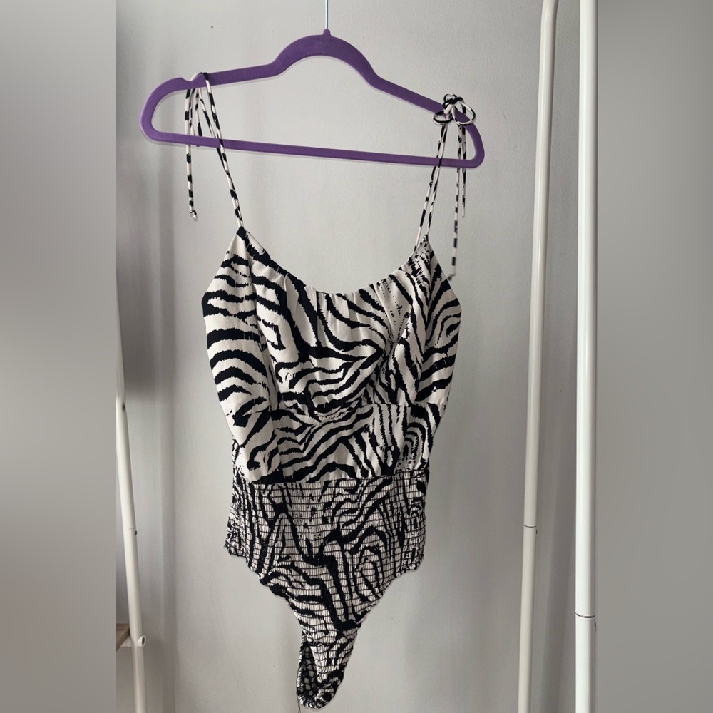 boutique cream and black animal print body suit